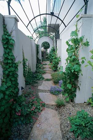 The arbors leading to the courtyard, here and opposite center, pay homage to interior eyebrow arches—all reminiscent of European villa architecture.